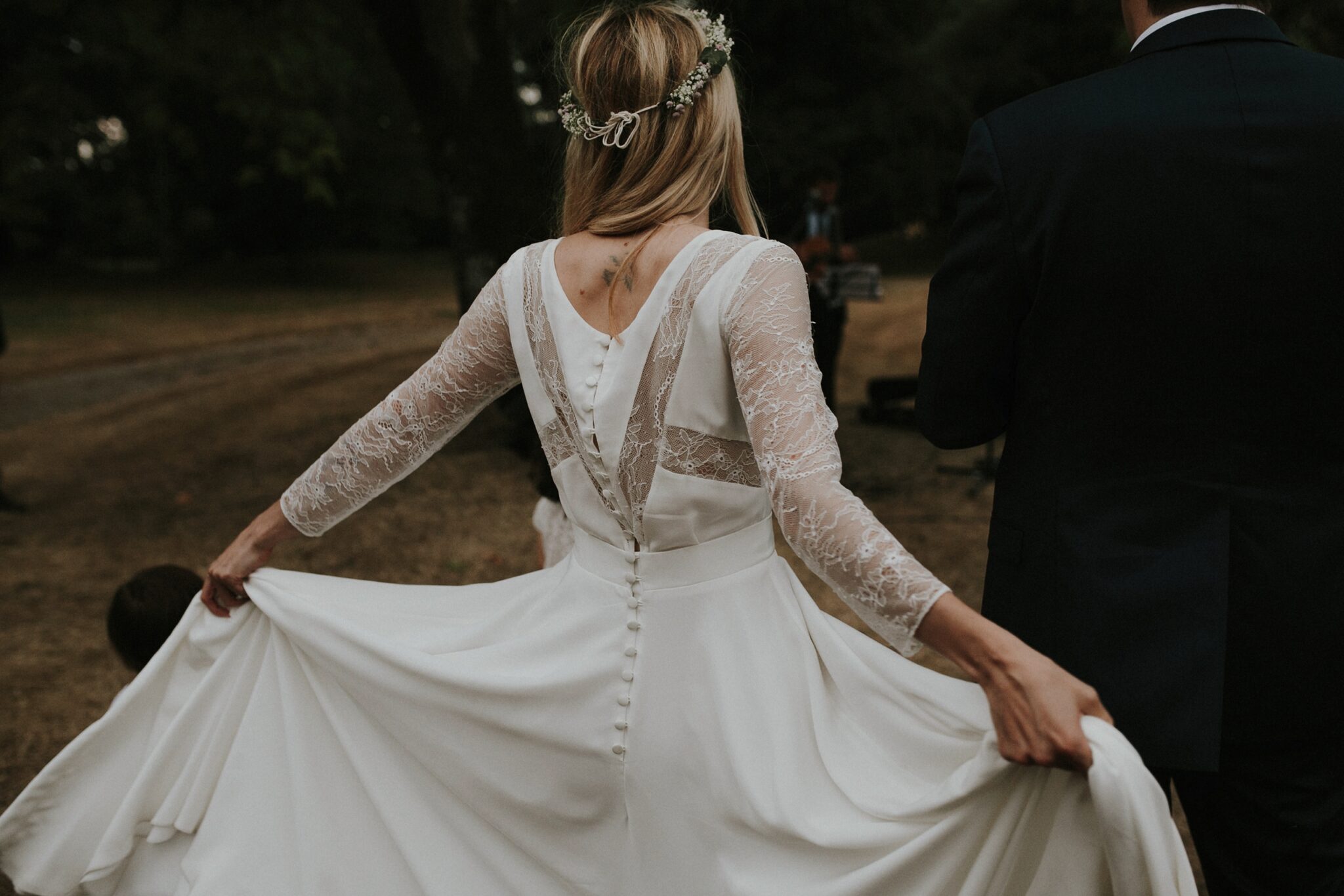 Modern bride dancing holding her designer gown on her wedding