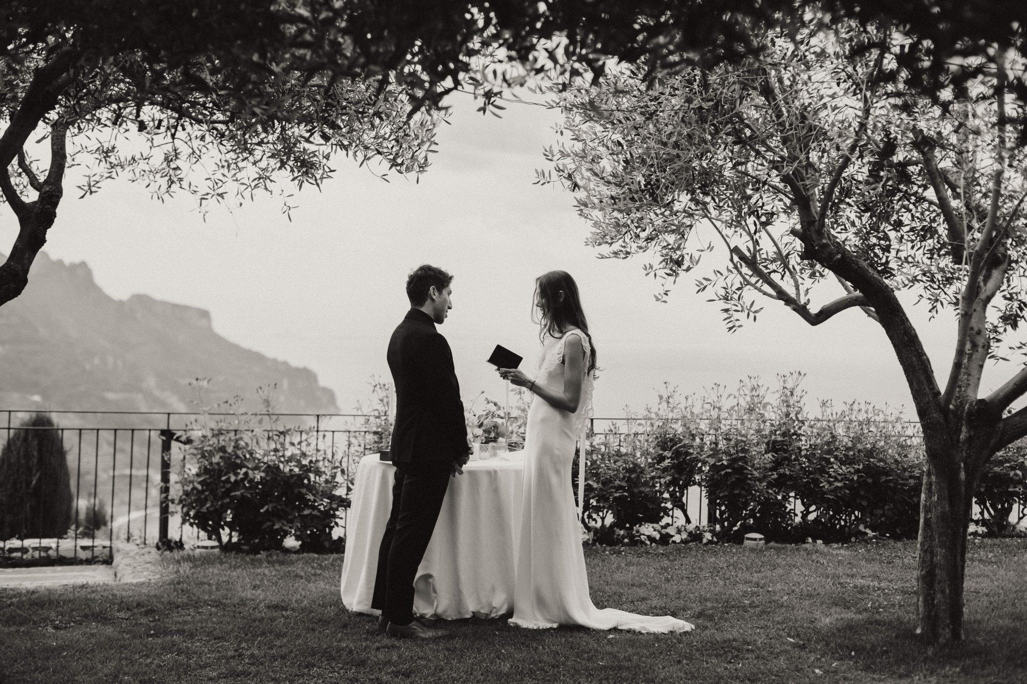 Bride and groom exchanging vows during an outdoor ceremony at the Belmond hotel in Ravello on their elopement day in Italy
